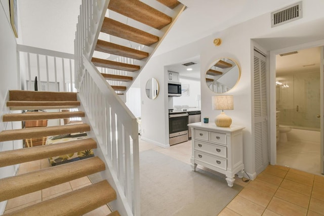 stairs with tile patterned floors