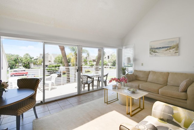 living room featuring light tile patterned floors and high vaulted ceiling