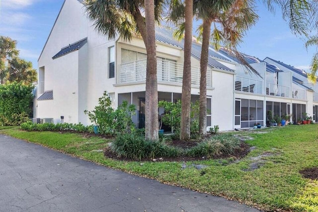 view of property exterior with a lawn