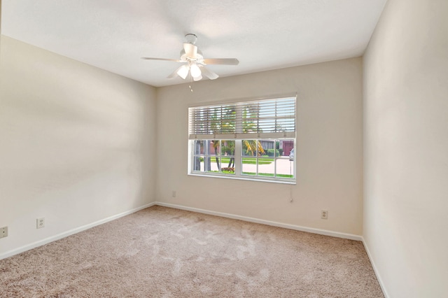 empty room featuring carpet and ceiling fan