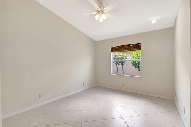 empty room with ceiling fan and light tile patterned flooring