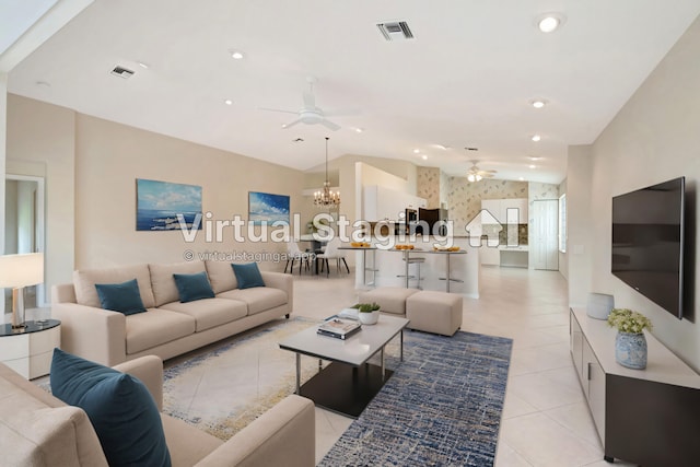 tiled living room with ceiling fan with notable chandelier and vaulted ceiling