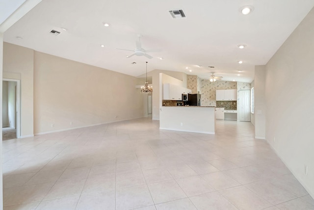 unfurnished living room with light tile patterned floors, ceiling fan with notable chandelier, and lofted ceiling