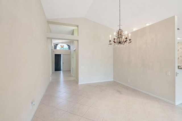 spare room with a chandelier, light tile patterned floors, and vaulted ceiling