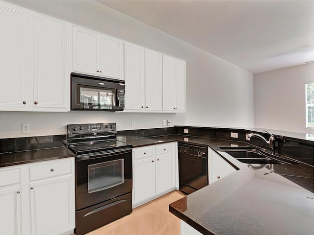 kitchen with dark stone counters, white cabinetry, sink, and black appliances