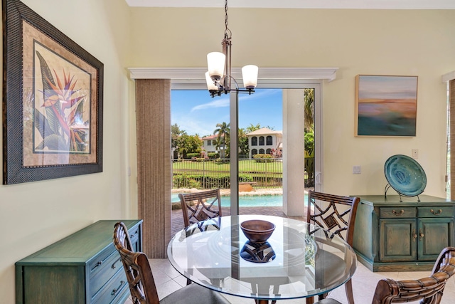 dining space featuring a notable chandelier, plenty of natural light, and light tile patterned flooring