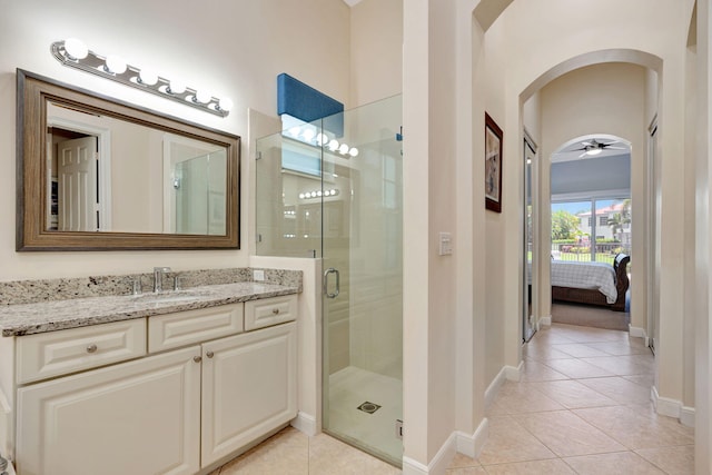 bathroom featuring vanity, tile patterned floors, an enclosed shower, and ceiling fan