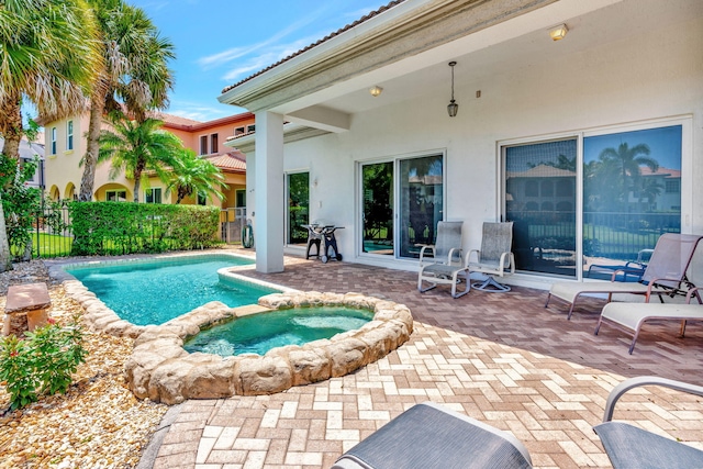 view of swimming pool with a patio area and an in ground hot tub