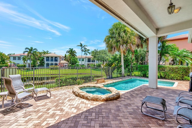 view of swimming pool featuring an in ground hot tub and a patio