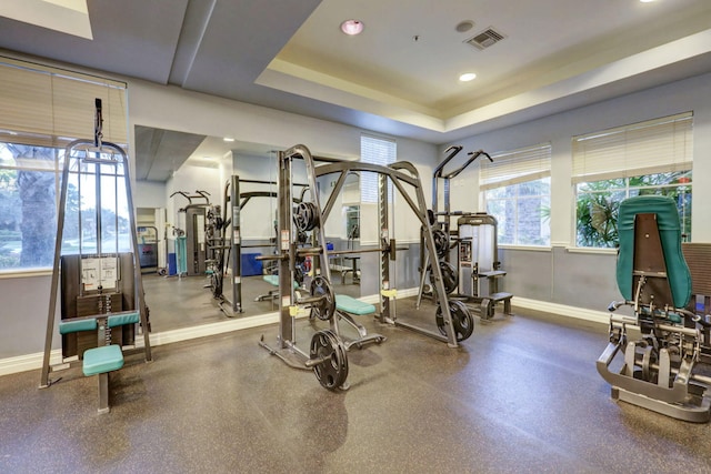 exercise area featuring a tray ceiling