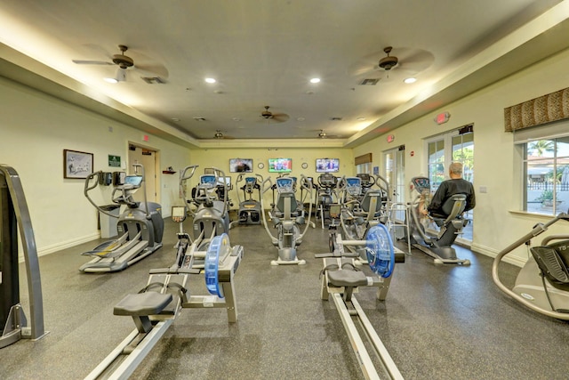 gym featuring a tray ceiling