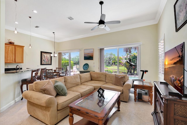 living room with light tile patterned floors, ceiling fan, and crown molding