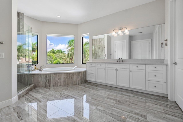 bathroom with shower with separate bathtub and vanity