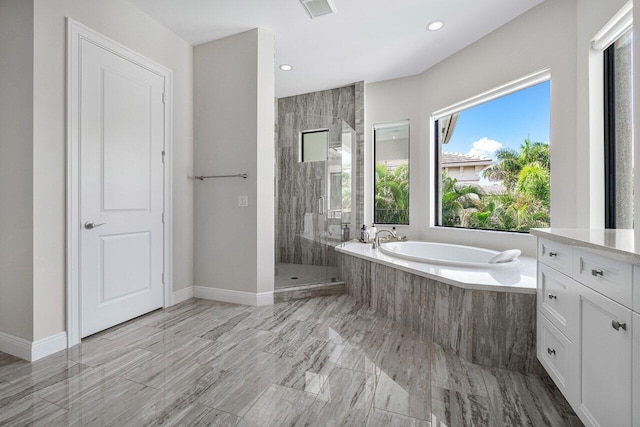 bathroom featuring shower with separate bathtub