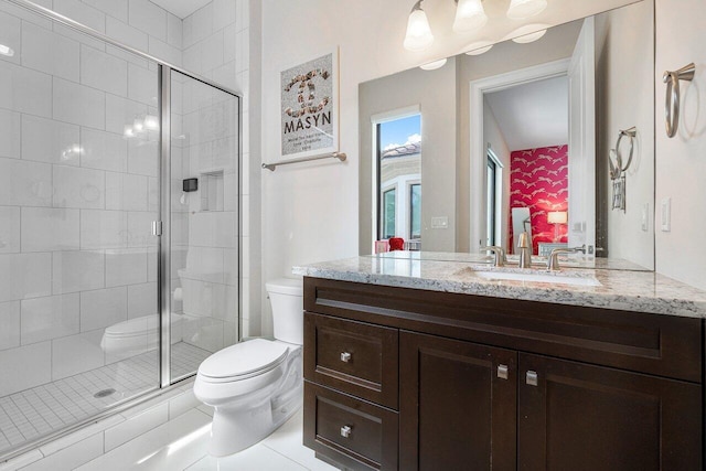 bathroom with toilet, tile patterned flooring, an enclosed shower, and vanity