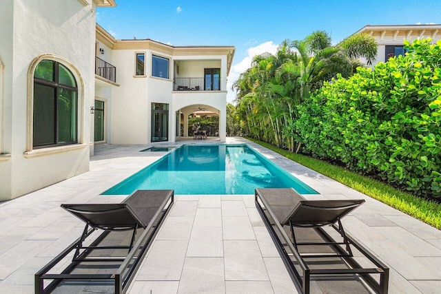 view of pool with a jacuzzi and a patio