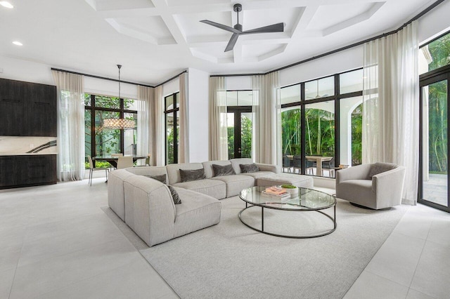 living room featuring ceiling fan, light tile patterned floors, and coffered ceiling