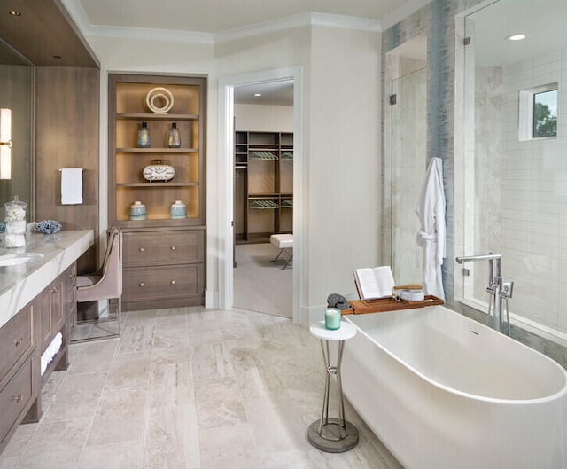 bathroom with built in shelves, crown molding, vanity, and independent shower and bath