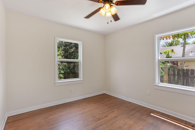 unfurnished room with ceiling fan and hardwood / wood-style flooring