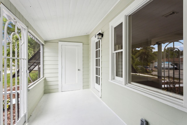 sunroom featuring a wealth of natural light and lofted ceiling