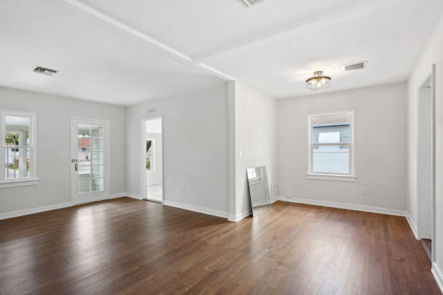 unfurnished room with dark wood-type flooring