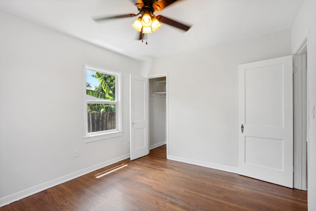 unfurnished bedroom with a closet, ceiling fan, and dark wood-type flooring