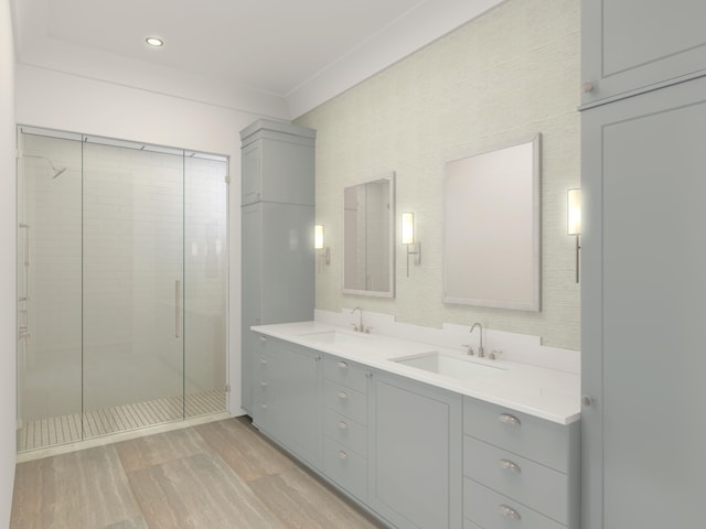 bathroom with wood-type flooring, an enclosed shower, and dual bowl vanity