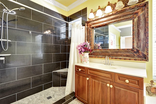 bathroom with crown molding, vanity, and walk in shower