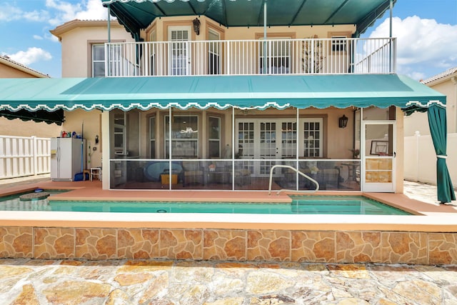 rear view of property with a balcony