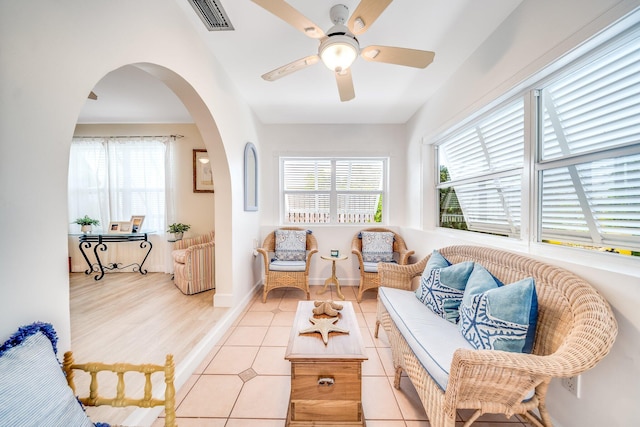 tiled living room with ceiling fan