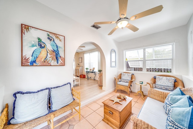 tiled living room featuring a wealth of natural light and ceiling fan