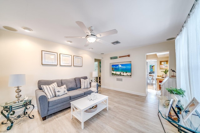 living room featuring ceiling fan and light hardwood / wood-style flooring