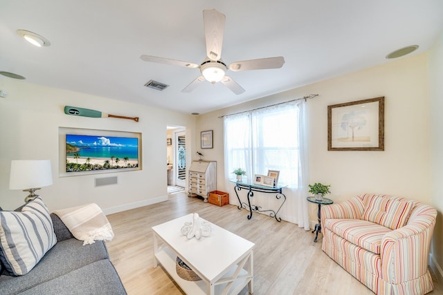 living room with light hardwood / wood-style floors and ceiling fan