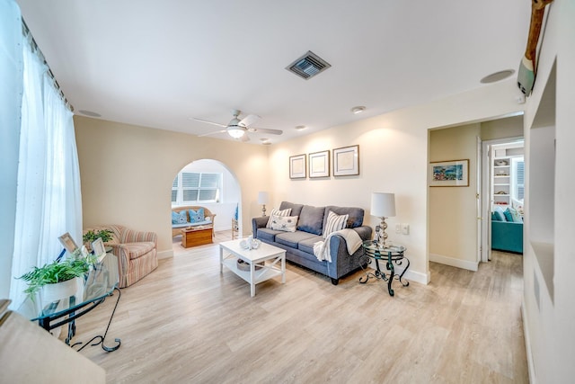 living room featuring light hardwood / wood-style flooring and ceiling fan