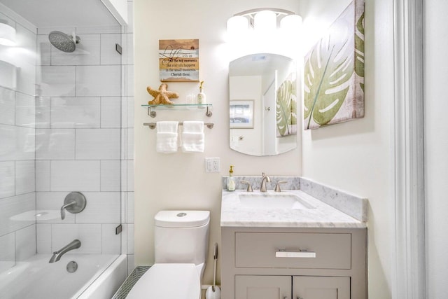 full bathroom with vanity, toilet, and tiled shower / bath