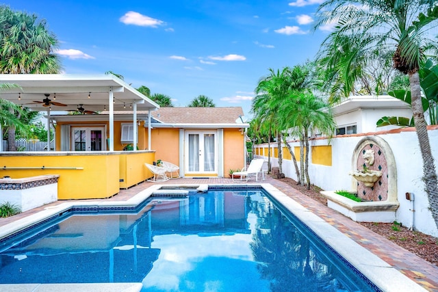 view of pool featuring ceiling fan, an in ground hot tub, and french doors