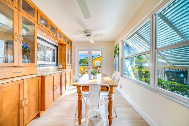 dining area featuring ceiling fan, french doors, and light hardwood / wood-style floors