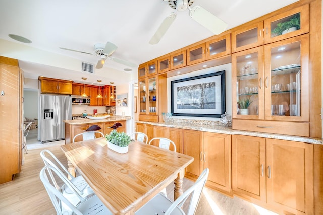 dining area featuring light hardwood / wood-style floors and ceiling fan