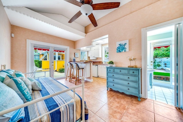 tiled bedroom with ceiling fan, lofted ceiling, and multiple windows