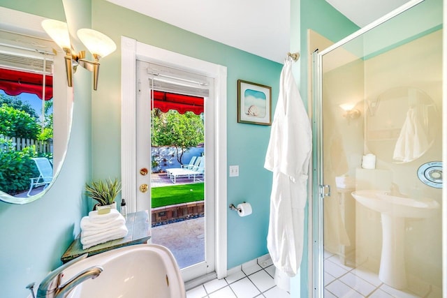 bathroom with tile patterned flooring, a shower with door, and sink