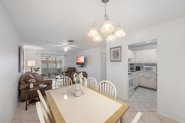 dining area featuring ceiling fan with notable chandelier