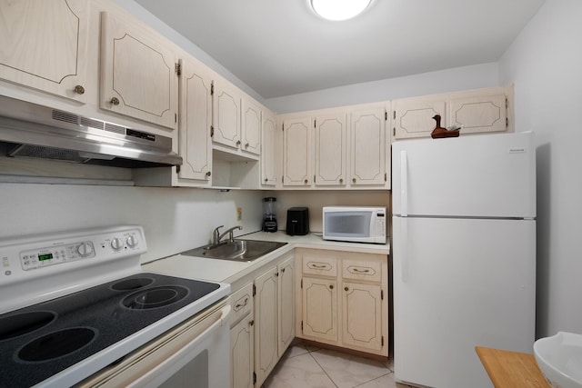 kitchen featuring light tile patterned flooring, sink, and white appliances