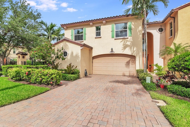 mediterranean / spanish-style home featuring a garage