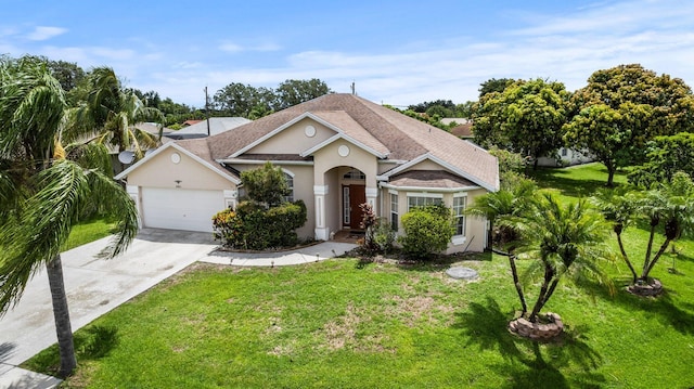 view of front of house with a garage and a front lawn