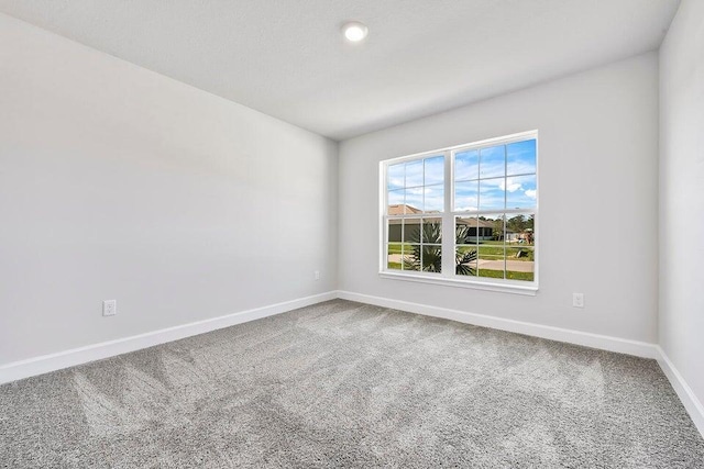 carpeted empty room featuring ceiling fan and lofted ceiling