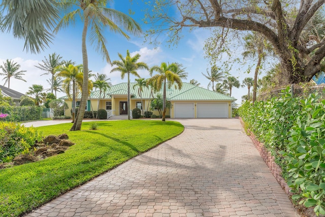 ranch-style home with a front lawn and a garage