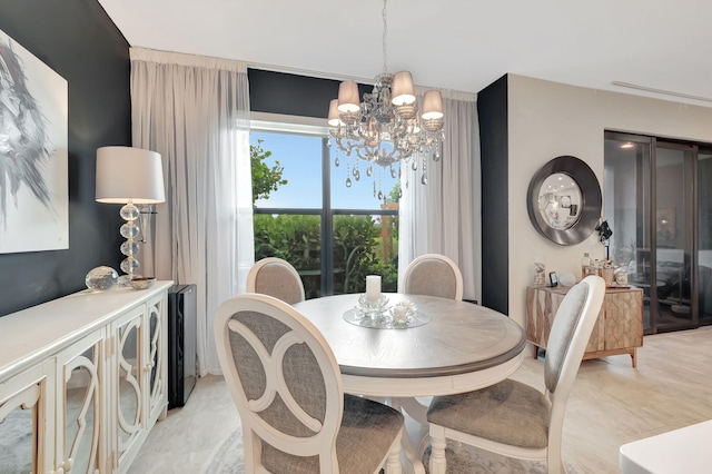 dining room featuring wine cooler and a notable chandelier