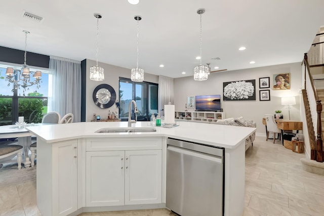 kitchen featuring sink, a kitchen island with sink, dishwasher, and white cabinets