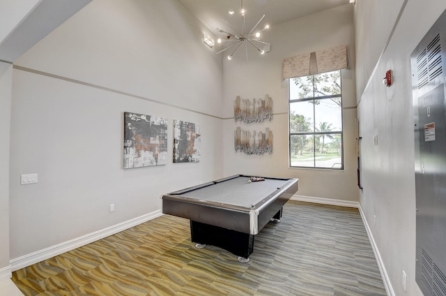 recreation room featuring a chandelier, billiards, and a towering ceiling