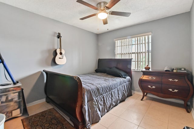 tiled bedroom featuring a textured ceiling and ceiling fan